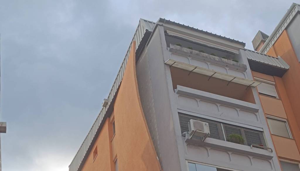 Po neurju na Planini s stanovanjskega bloka nevarno visi del fasade, na družbenih omrežjih se vrstijo očitki