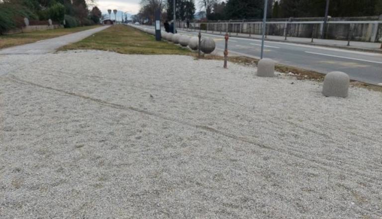 Potniki na Žalah brez pločnika in klopi, čakajo na kamnitih kroglah